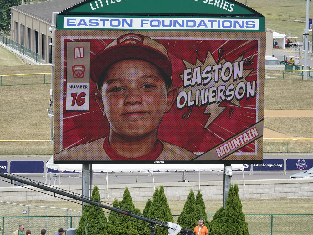 A picture of Mountain Region Champion Little League team member Easton Oliverson, from Santa Clara, Utah, is shown on the scoreboard at Volunteer Stadium during the opening ceremony of the 2022 Little League World Series baseball tournament in South Williamsport, Pa., on Wednesday.