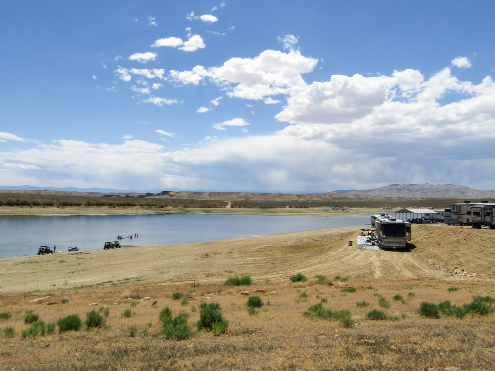 The Buckboard Marina on the Green River in Wyoming is about 50 miles southwest of the Jim Bridger coal plant. The sagebrush turns to sand marking where the Green River water has fallen. The falling water also means the marina owners must continuously adjust the ramp to the boats.