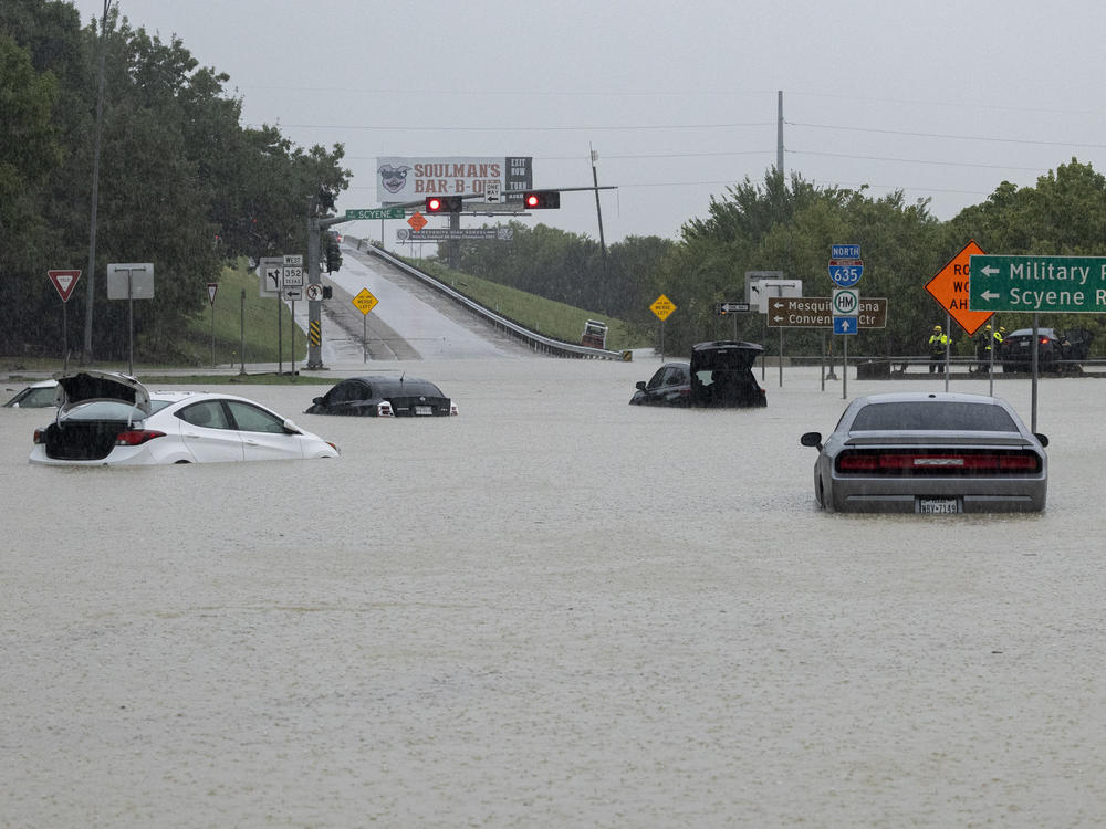 Stalled cars sit abandoned on the flooded Interstate 635 Service Road on Monday in Mesquite, Texas.