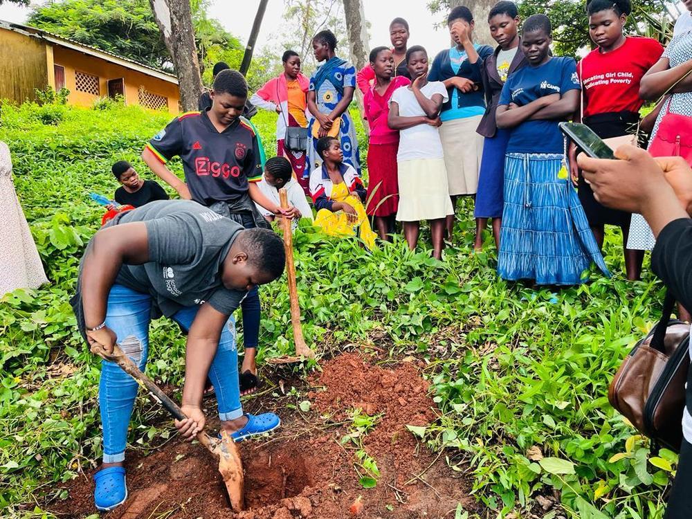 Tawonga Zakeyu (foreground, left) demonstrates pit planting<strong> </strong>-- which can prevent water runoff and erosion — for young women on a farm in Thekerani, Malawi. Zakeyu helps train women farmers.