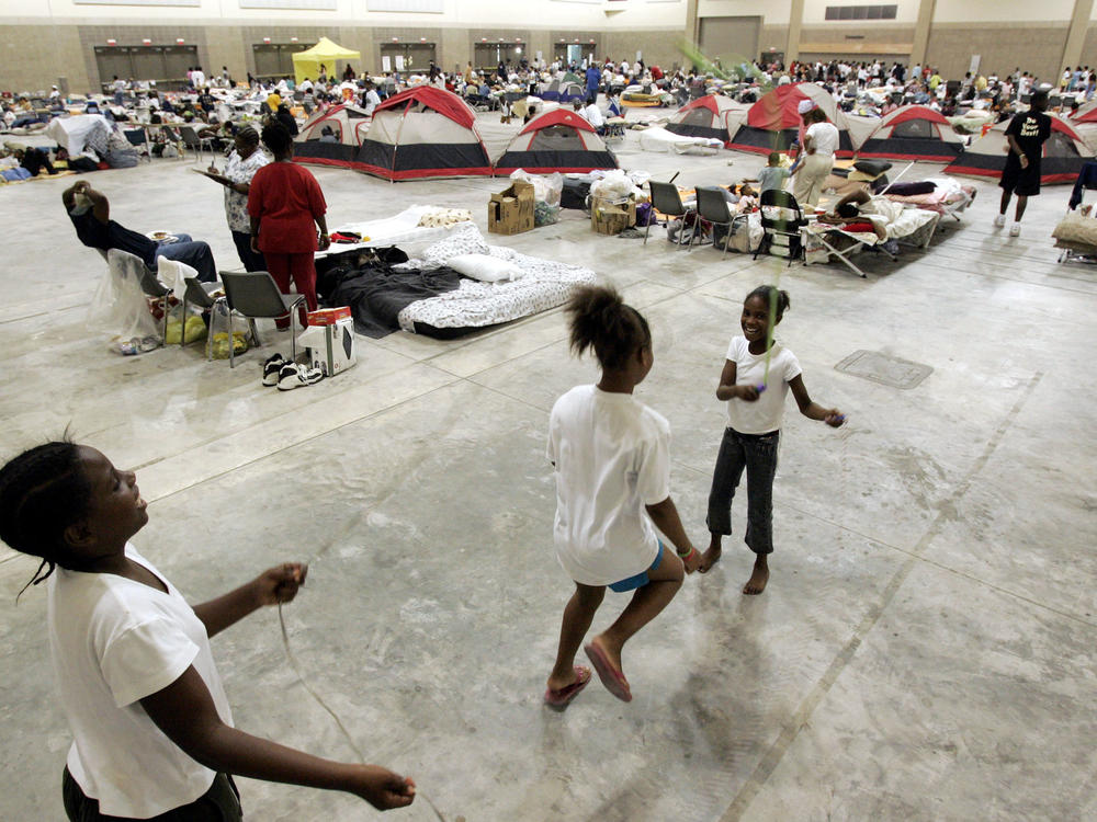 Children from the New Orleans area play jump rope to pass the time at the Red Cross shelter at the River Center on September 2, 2005 in Baton Rouge, Louisiana