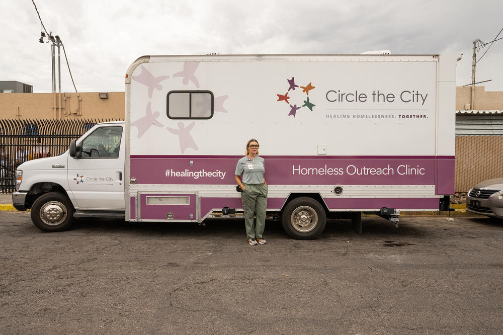 Nina Gomez, a psychiatric nurse practitioner with Circle the City, stands with the nonprofit organization's mobile medical unit.