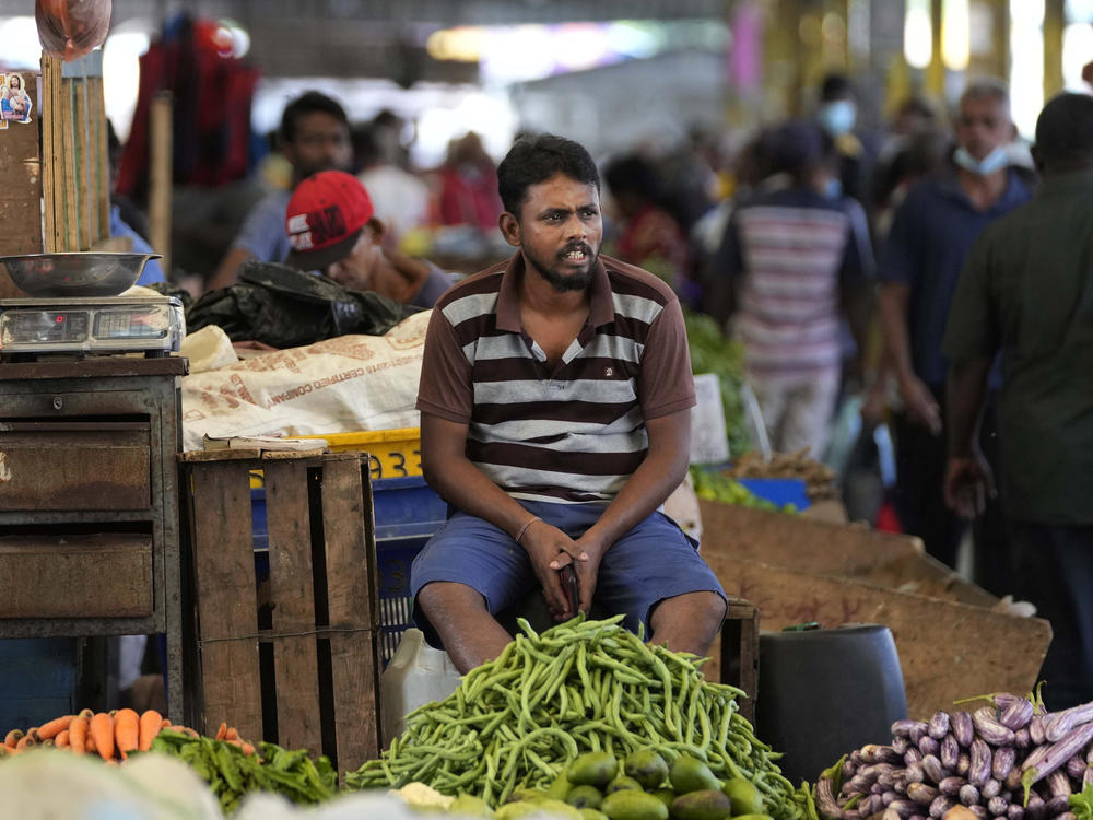 A vender waits for customers at a vegetable market place in Colombo, Sri Lanka, Friday, June 10, 2022.