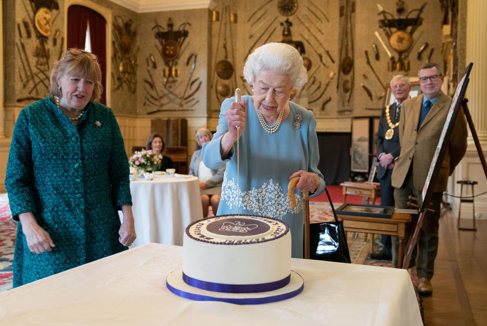 <strong>February 5, 2022</strong>: Queen Elizabeth II cuts a cake to celebrate the start of the Platinum Jubilee during a reception in the Ballroom of Sandringham House in King's Lynn, England.