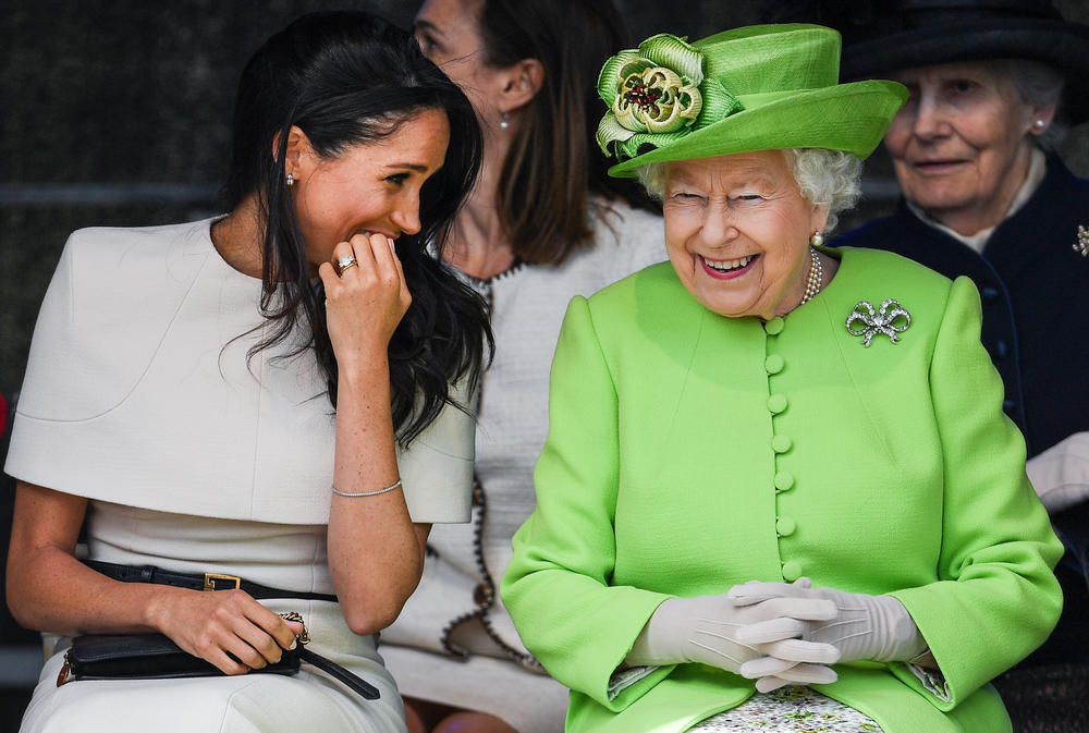 <strong>June 14, 2018: </strong>Queen Elizabeth II laughs with Meghan Markle, Duchess of Sussex, during the pair's first engagement at a ceremony to open the new Mersey Gateway Bridge in the town of Widnes in Halton, Cheshire, England. Markle married Prince Harry in May 2018.