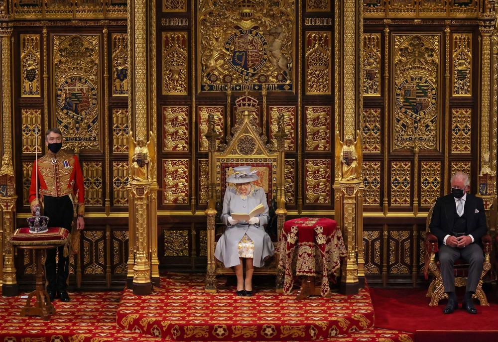 <strong>May 11, 2021:</strong> Queen Elizabeth II reads the Queen's Speech on the Sovereign's Throne as Prince Charles (right) listens in the House of Lords chamber during the State Opening of Parliament at the Houses of Parliament in London, England.