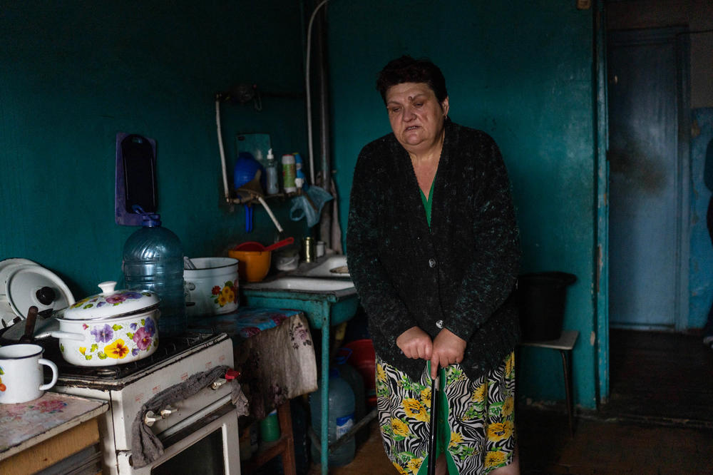 Victoria Bondarenko stands in her apartment in Izium. 