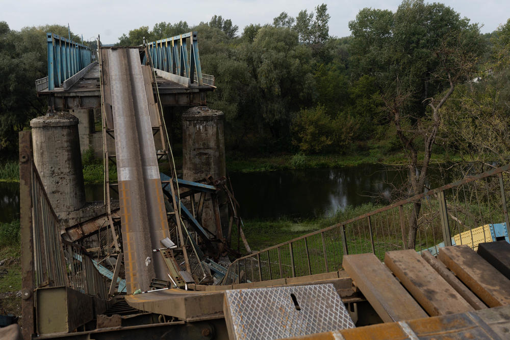 A collapsed bridge over a river in Izium. Ukrainian armed forces estimate 80% of the city is ruined from the violence.