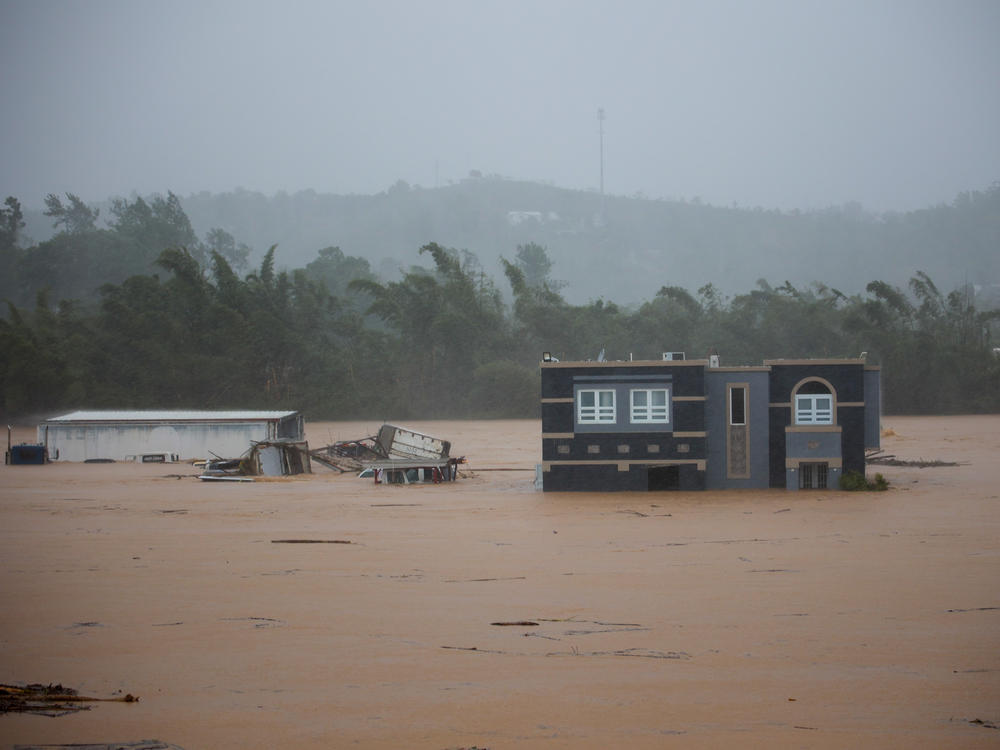 A home is submerged in floodwaters caused by Hurricane Fiona in Cayey, Puerto Rico, on Sunday.