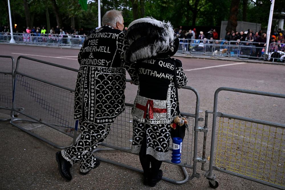 A Pearly King and Queen line the Procession Route in London.