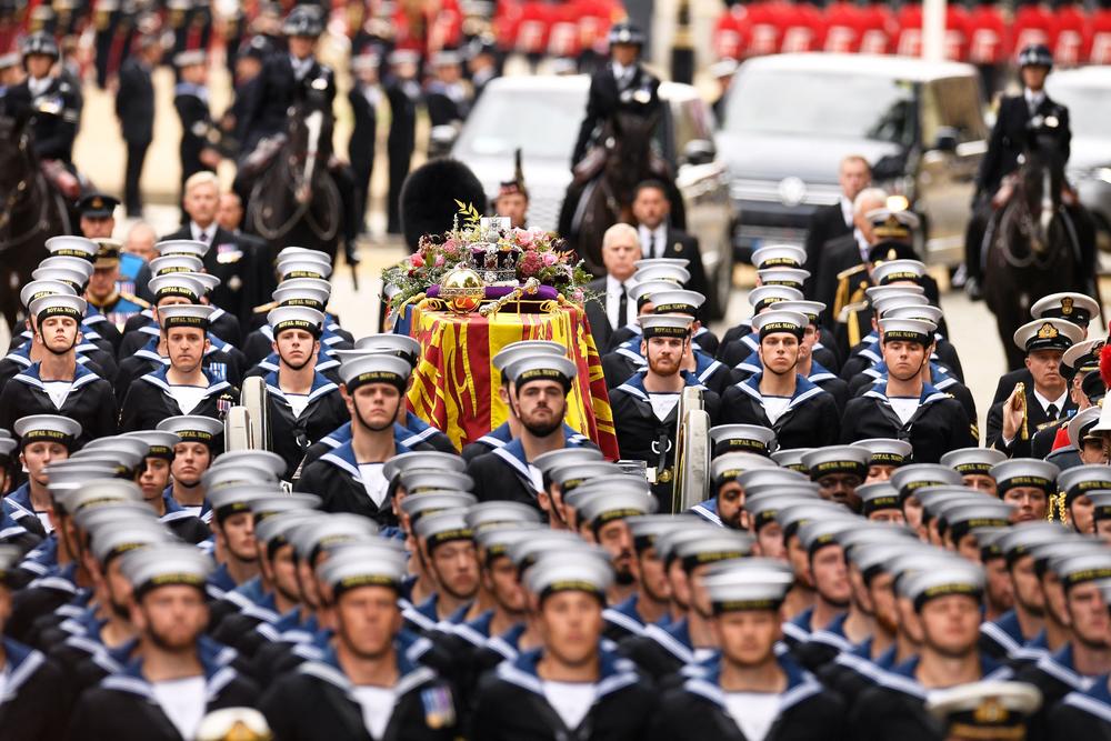 Royal Navy sailors take the coffin of Queen Elizabeth II, draped in a Royal Standard and on the State Gun Carriage of the Royal Navy to Westminster Abbey for the State Funeral Service for Britain's Queen Elizabeth II.