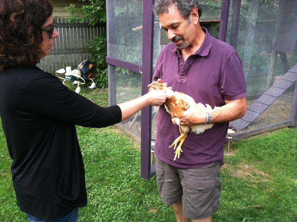 Ken shows off one of his many chickens to colleague Andrea de Leon in 2013.