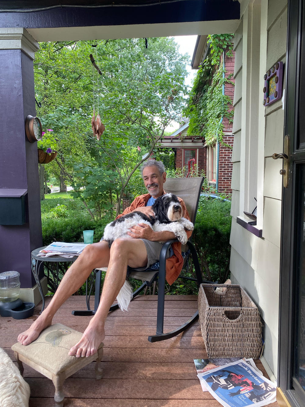 Ken enjoys a front-porch snuggle with Petey, his daughter Kate's dog, on Father's Day 2022.