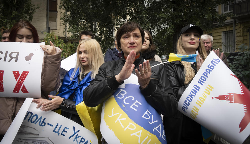 Residents of Mariupol hold a rally with banners reading 