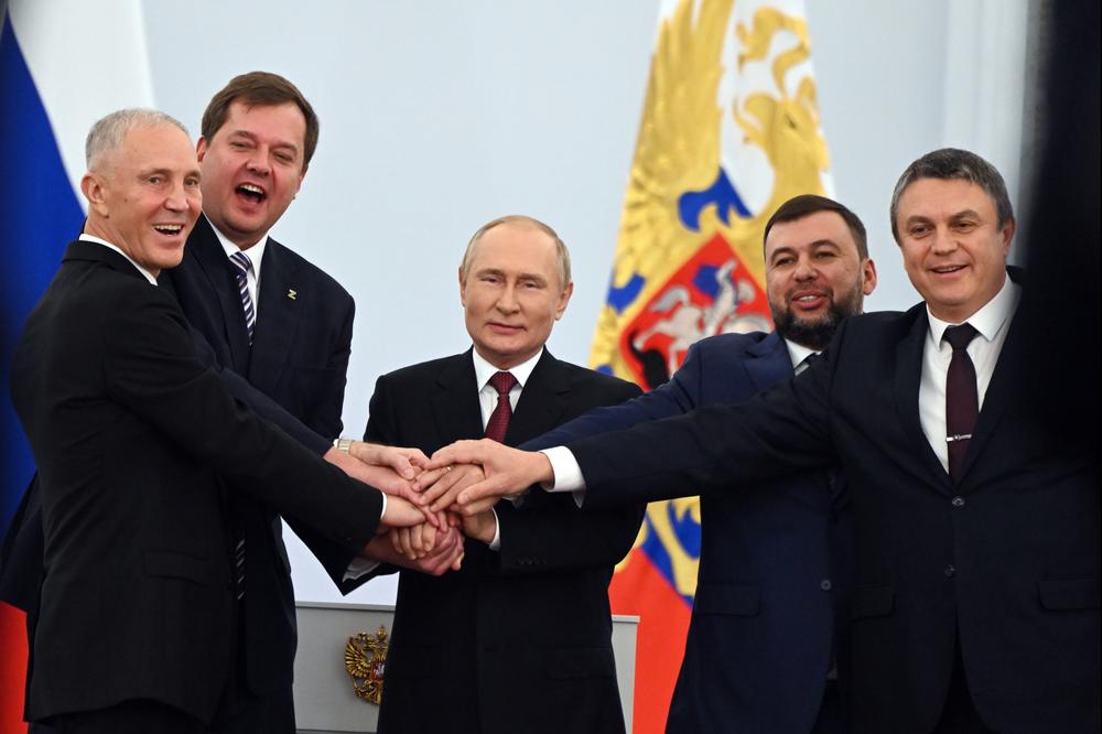 From left: Moscow-appointed head of Kherson region Vladimir Saldo and head of Zaporizhzhia region Yevgeny Balitsky, Russian President Vladimir Putin, Denis Pushilin, leader of self-proclaimed Donetsk People's Republic and Leonid Pasechnik, leader of self-proclaimed Luhansk People's Republic, at a ceremony at the Kremlin on Friday to sign treaties for the four regions of Ukraine to join Russia.