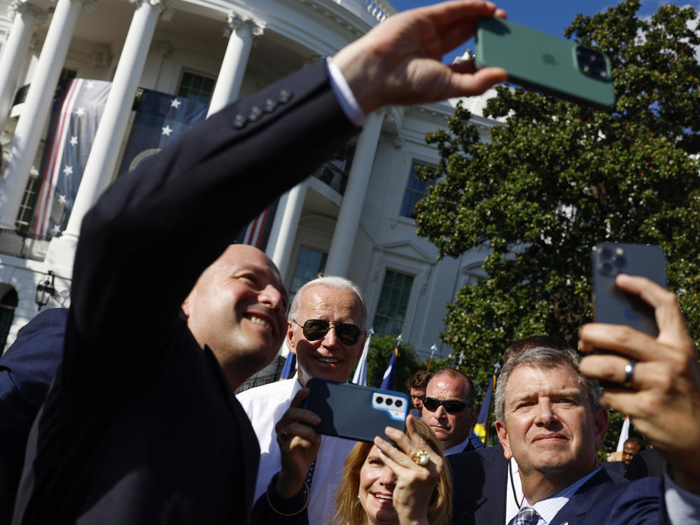 President Biden takes pictures with guests after speaking at an event celebrating the passage of the Inflation Reduction Act on the South Lawn of the White House on Sept. 13.