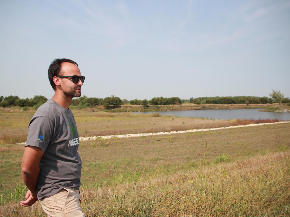 Flooding levee district board member Regan Griffin surveys his farmland in Atchison County, Missouri on Sept. 14, 2022. A pond marks where a levee was breached during the 2019 flood of the Missouri River, flooding Griffin's farmland. The board hopes to set this levee back in the future.