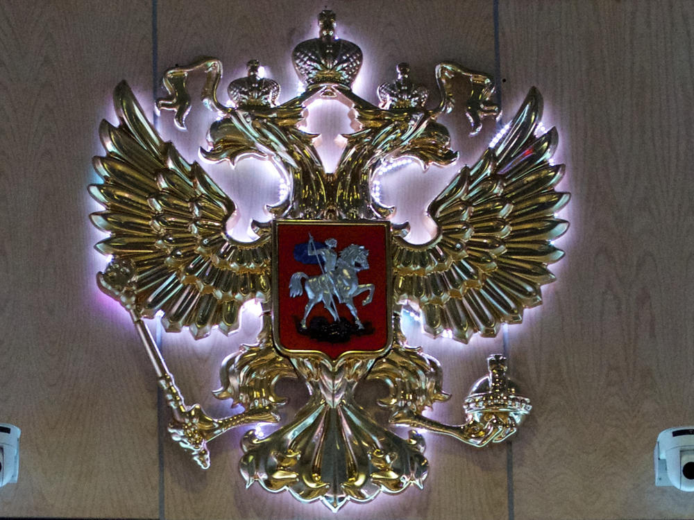 The emblem for the Russian Defense Ministry is displayed at the ministry's building in Moscow. Officials say 11 soldiers were killed and 15 wounded in a shooting at a military facility near Ukraine.