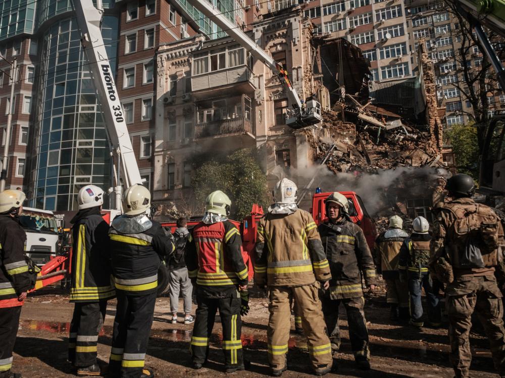 Ukrainian firefighters work on a destroyed building after a drone attack in Kyiv on Monday, amid the Russian invasion of Ukraine.