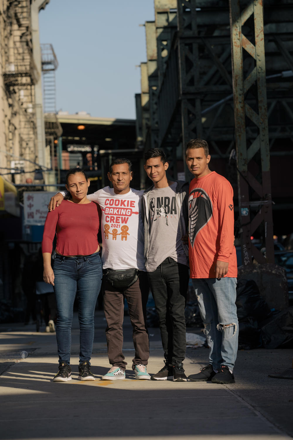 Milagros Pineda, Víctor Villegas, Daniel Villegas and Leiver Villegas stand for a portrait outside their temporary housing in Brooklyn.