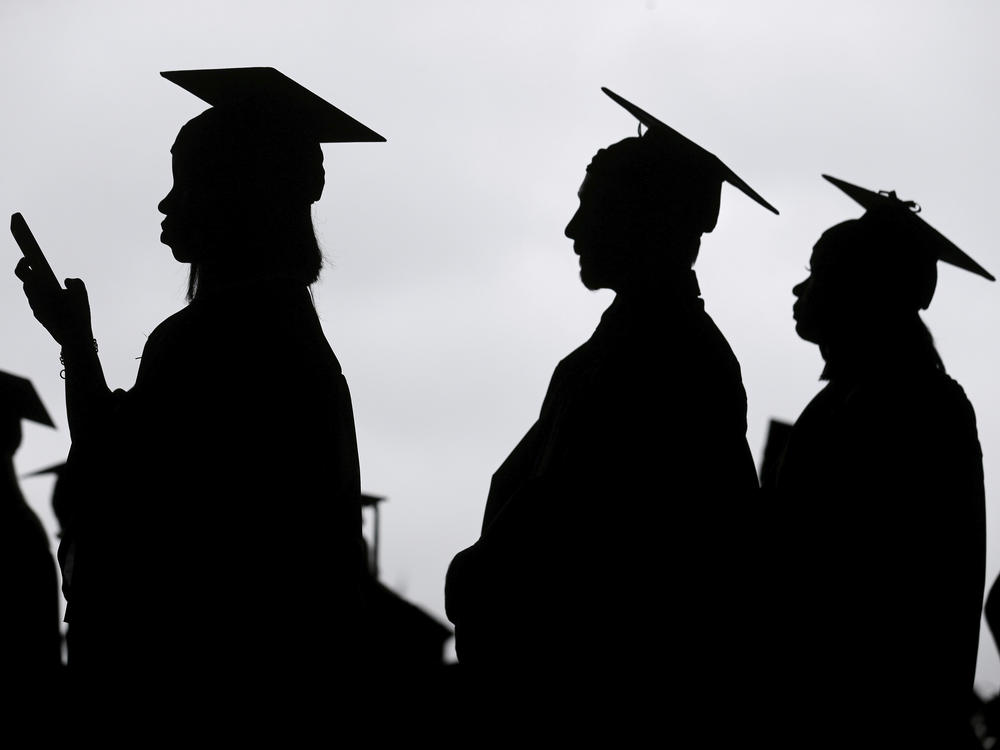 New graduates line up before the start of a community college commencement in East Rutherford, N.J., May 17, 2018.