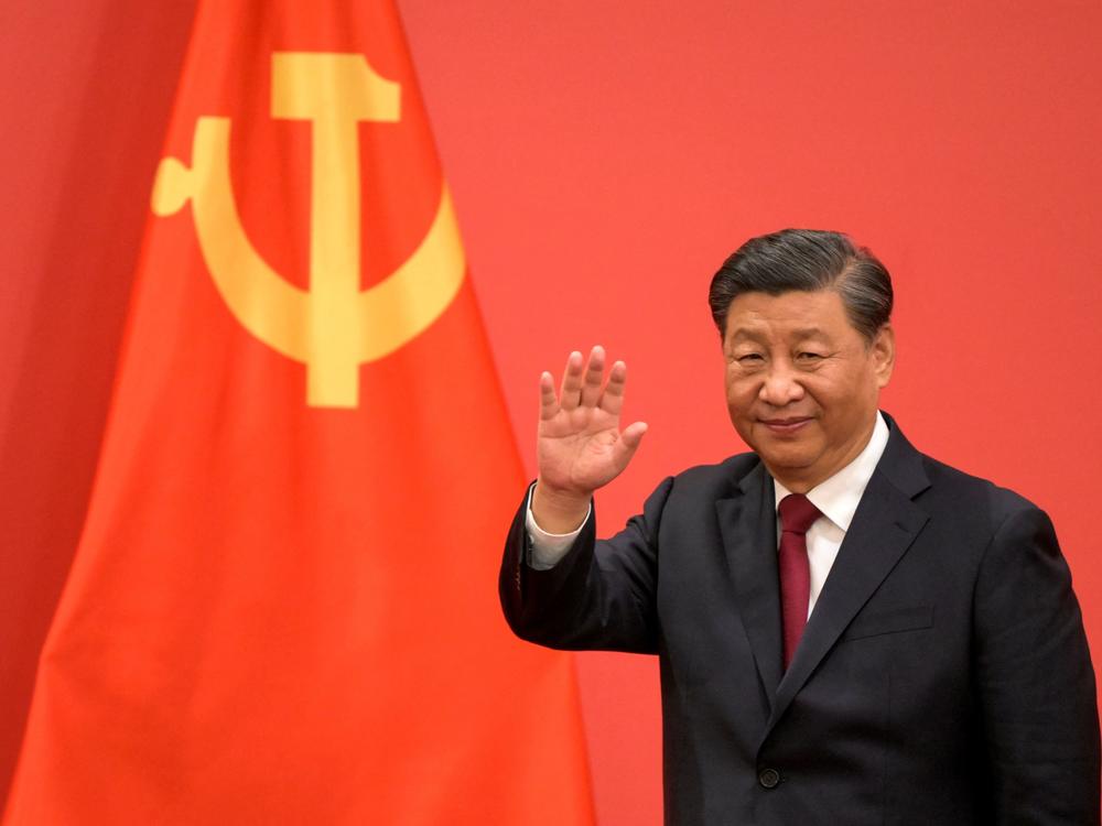 China's President Xi Jinping waves during the introduction of members of the Chinese Communist Party's new Politburo Standing Committee, the nation's top decision-making body, in Beijing on Sunday.