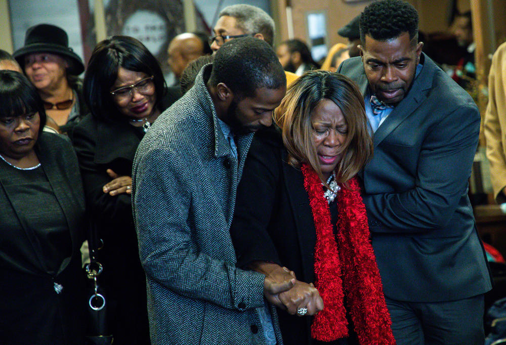 Glenda O'Neal is helped by family members as she walks out from the church after funeral services for her daughter Tamara O'Neal at the First Church of God in La Porte, Ind., on Nov. 30, 2018. Dr. Tamara O'Neal, 38, was one of three people shot at Mercy Hospital and Medical Center in Chicago.