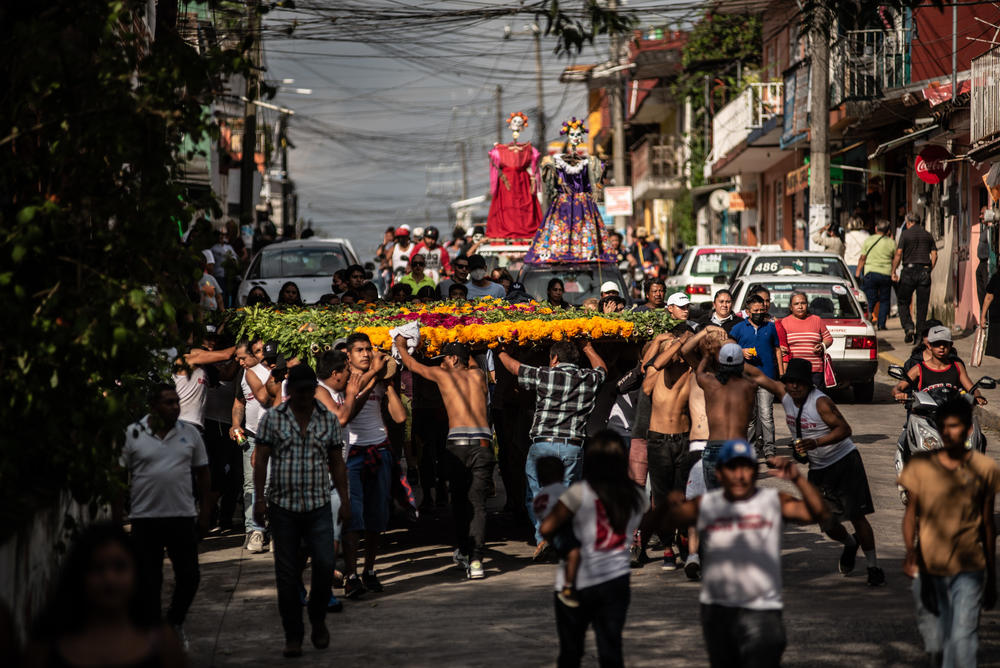 View of the floral arch offerings and life-size skulls that accompany the parade