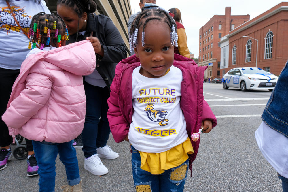 One of Benedict College's future tigers takes in the school's homecoming parade on Oct. 29, 2022, with a lollipop in hand.