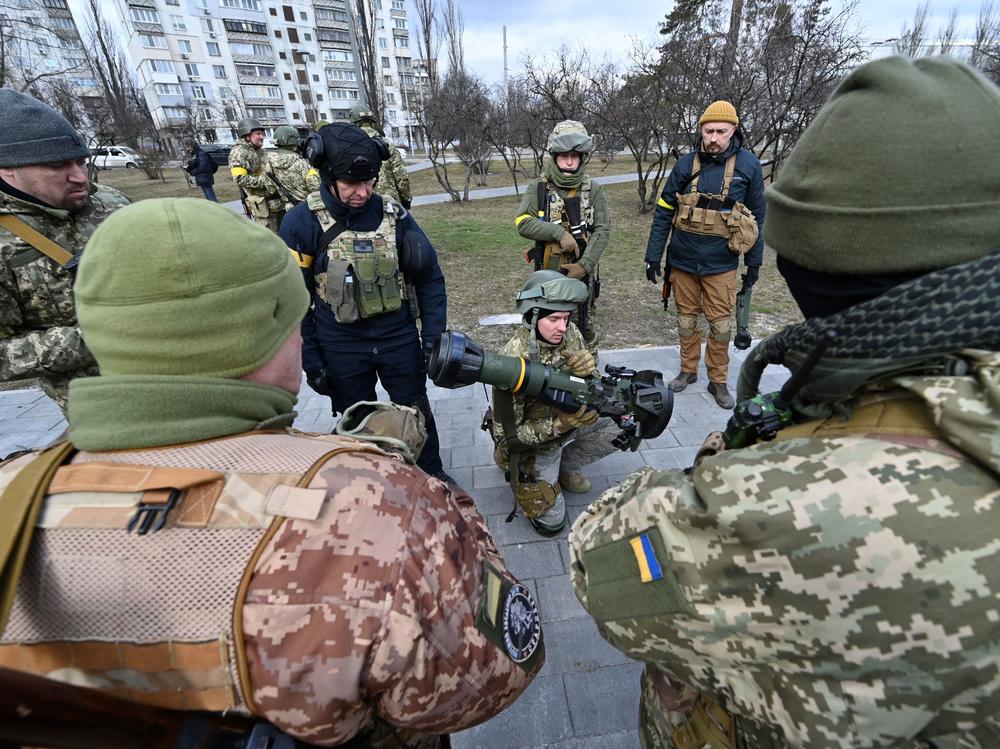 Members of the Ukrainian Territorial Defense Forces examine new armaments including NLAW anti-tank systems and other portable anti-tank grenade launchers, in Kyiv on March 9.
