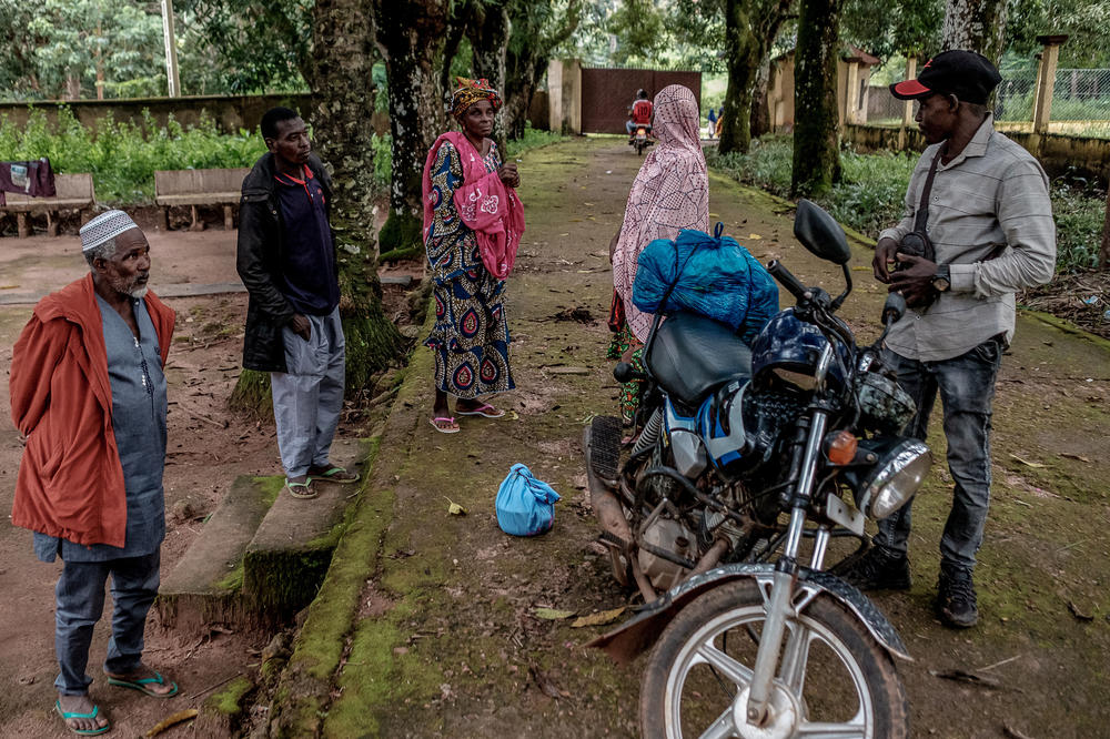 Fatoumata Lamourana is surrounded by her family as she gets ready to climb on the back of a motorbike and head home after five days of treatment and six doses of antivenom at the clinic.