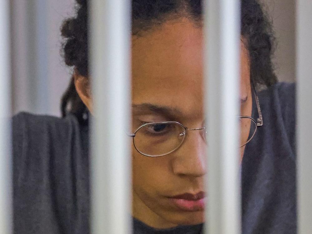 WNBA basketball player Brittney Griner, who was detained at Moscow's Sheremetyevo airport and later charged with illegal possession of cannabis, sits inside a defendants' cage after the court's verdict during a hearing in Khimki outside Moscow, on Aug. 4, 2022.