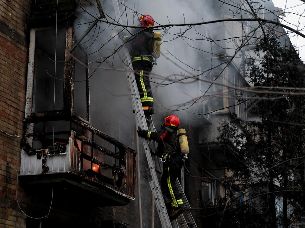 Firefighters work to put out a fire in a residential building hit by a Russian missile strike in Kyiv on Tuesday.