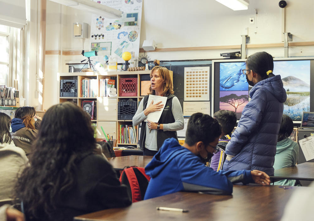 Sarah Slack, an eighth grade science teacher at J.H.S. 223 The Montauk in Brooklyn, explains to her students how to collect temperature data on their school playground.