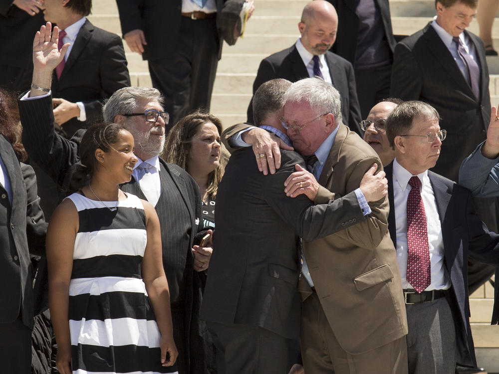 Jim Obergefell and fellow plaintiff Luke Barlowe hug as they exit the Supreme Court on April 28, 2015 after oral arguments concerning whether same-sex marriage is a constitutional right.