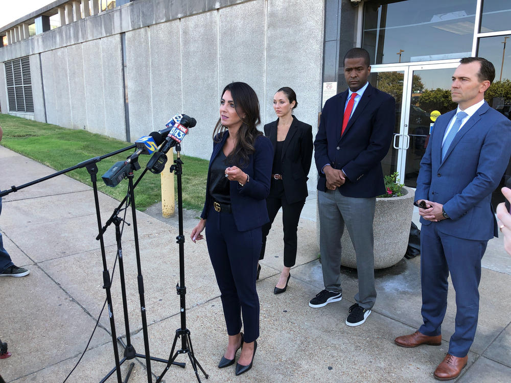 Attorney Alexandra Benevento, center, speaks with reporters during a news conference announcing a cheerleader abuse lawsuit filed in Tennessee on Tuesday, Sept. 27, 2022, in Memphis, Tenn.