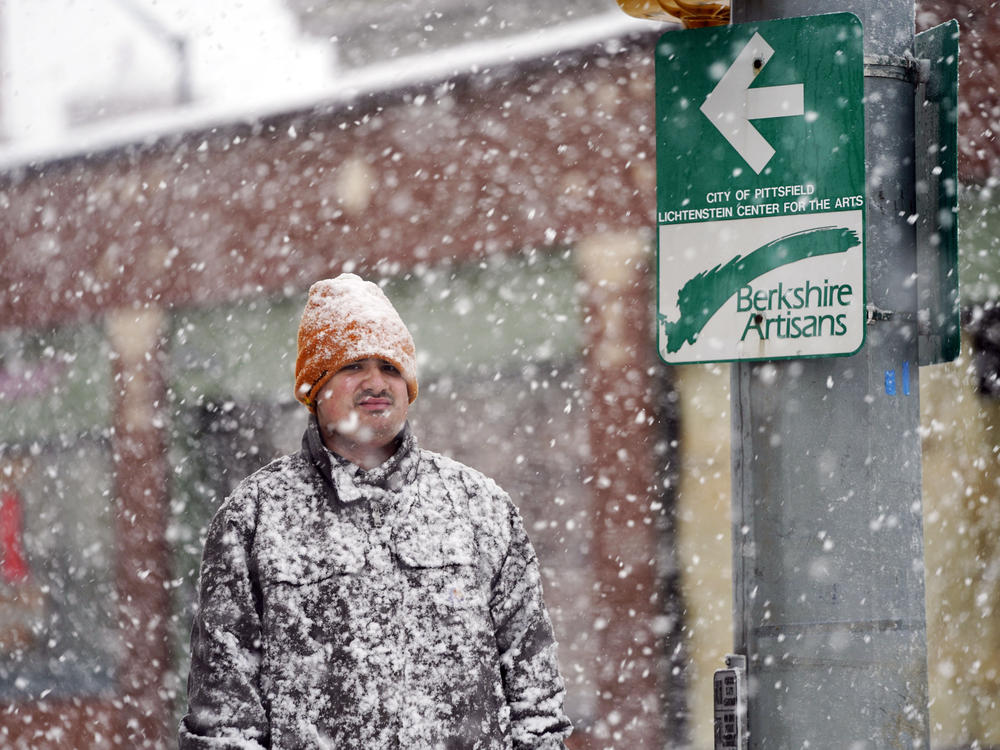 A man is covered in snow on Fenn Street in Pittsfield, Mass., Dec. 16, 2022.