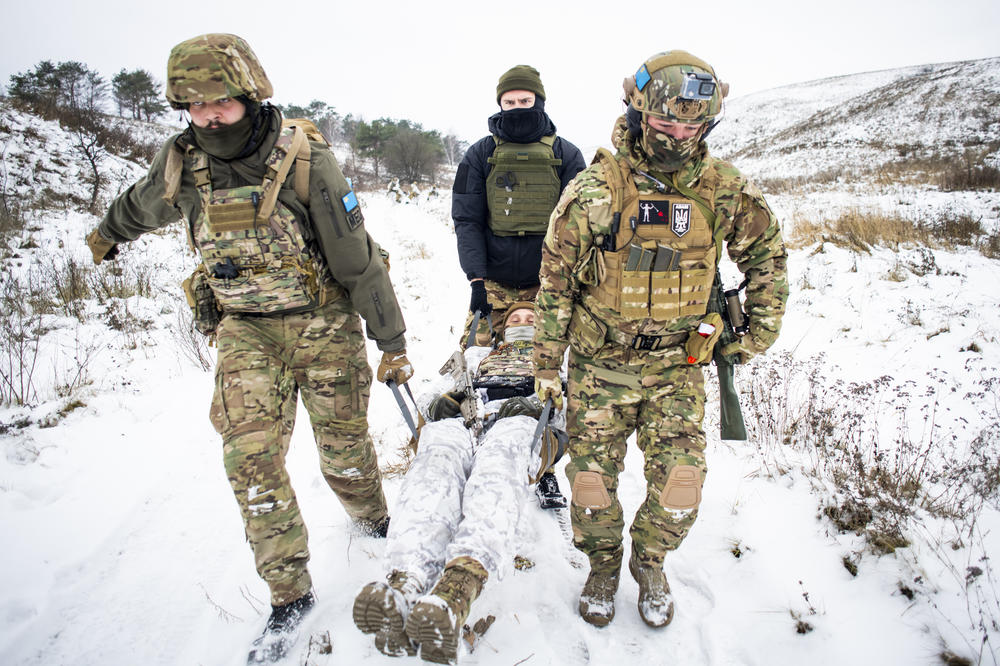 Members of the Dzhokhar Dudayev Battalion simulate carrying a casualty with new recruits outside Kyiv on Dec. 3.