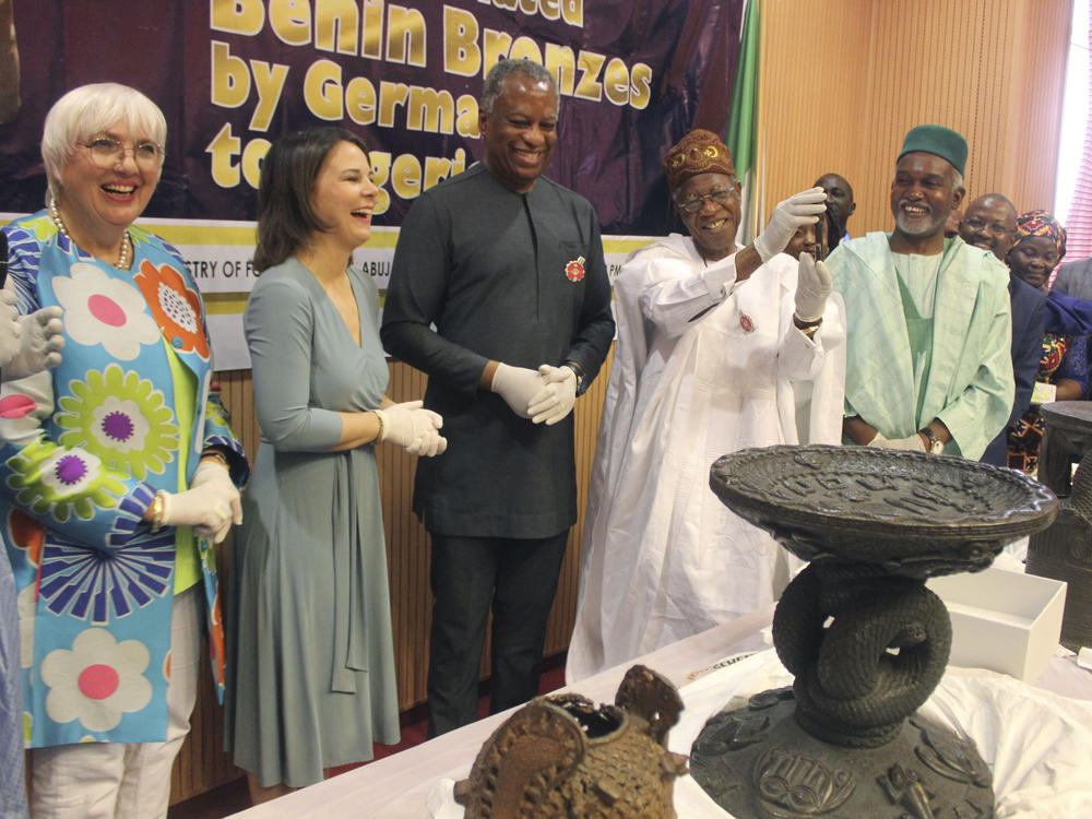 Germany's Foreign Minister Annalena Baerbock (second from left) and Nigeria's Minister of Information and Culture Alhaji Lai Mohammed (fourth from left) are pictured during the ceremony. Germany has returned 22 historic bronze sculptures to Nigeria as part of efforts to address what its foreign minister called its 