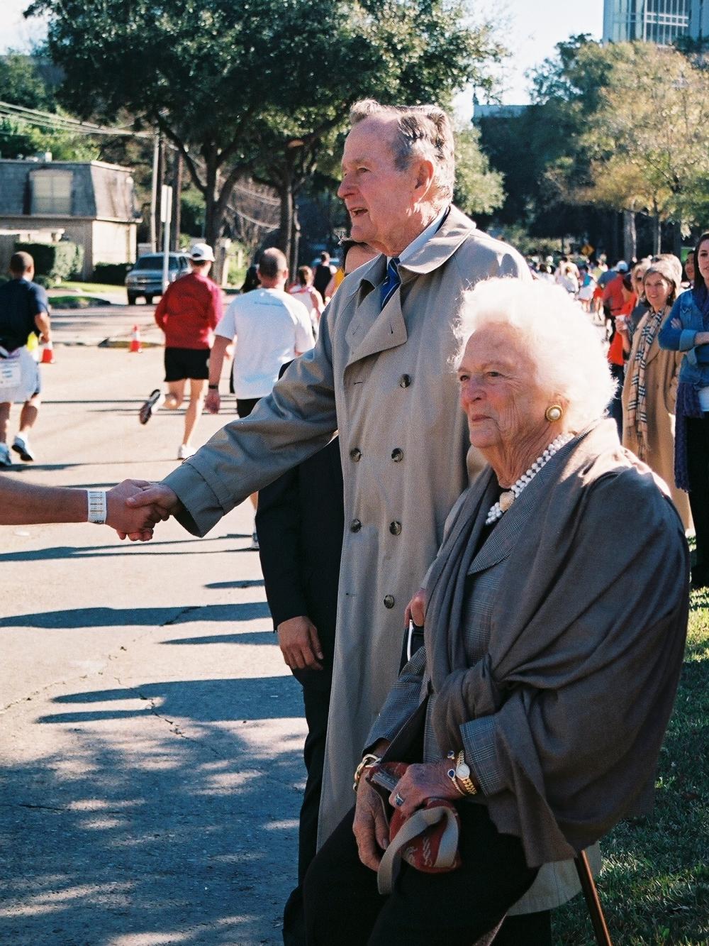 Former president George H.W. Bush and Barbara Bush greet runners participating in the Houston Marathon on Jan. 13, 2008. The route took participants past the Bushes church, St. Martin's Episcopal.