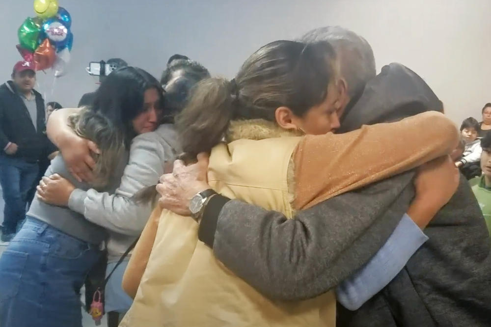 The Rodriguez Tellez family embraces as they are reunited.
