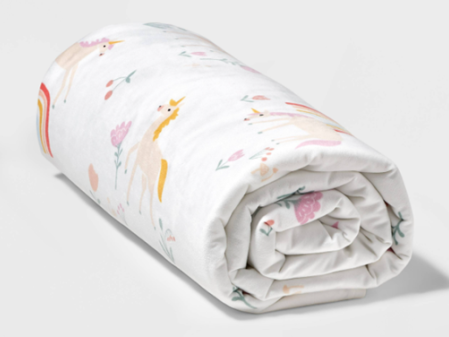 The children's Pillowfort weighted blanket is shown in unicorn pink. The item and its variations is being recalled at Target stores after two girls died from asphyxiation after becoming trapped under one.