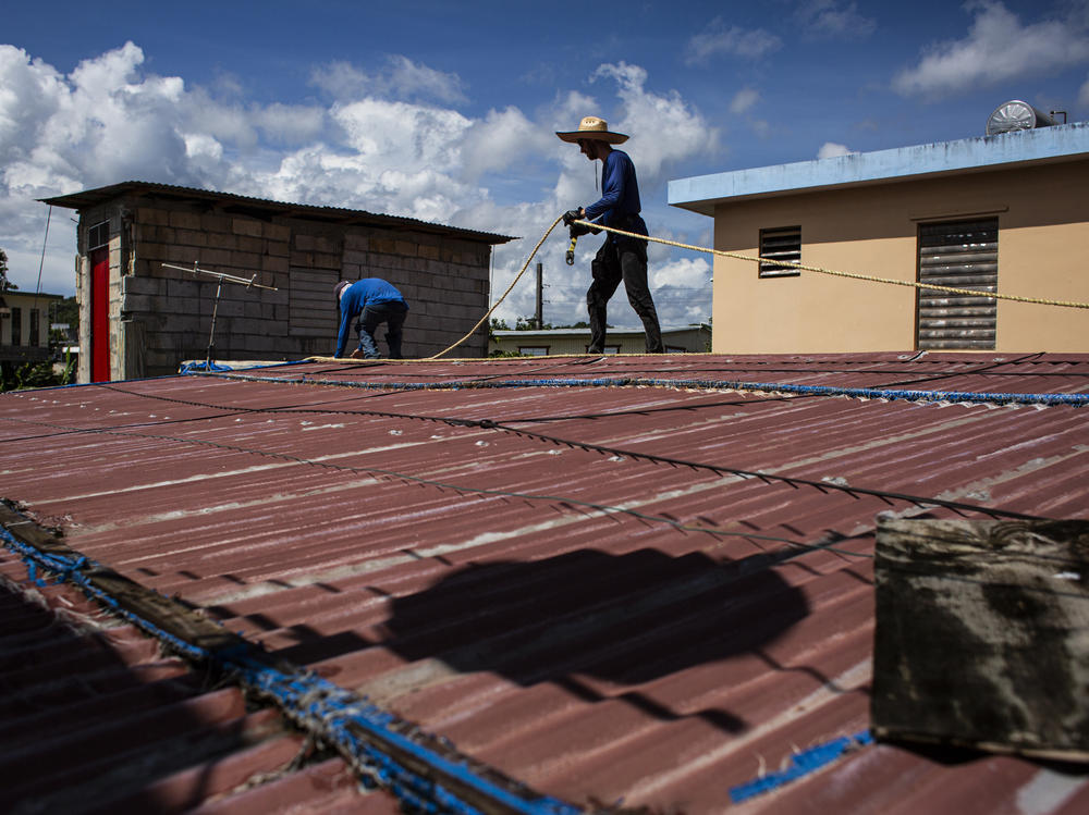 Construction apprentices prepare to replace a damaged roof in the town of Toa Baja, P.R. PRoTechos, the nonprofit they work with, was founded to fix the roofs of people who got little or no government help after Hurricane Maria devastated the island in 2017.
