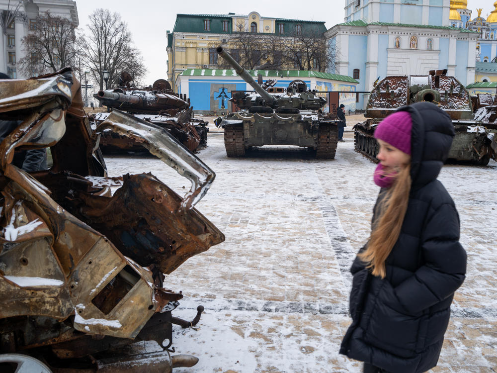 People look at destroyed Russian military vehicles on display in central Kyiv on a snowy afternoon in the capital city on January 9.