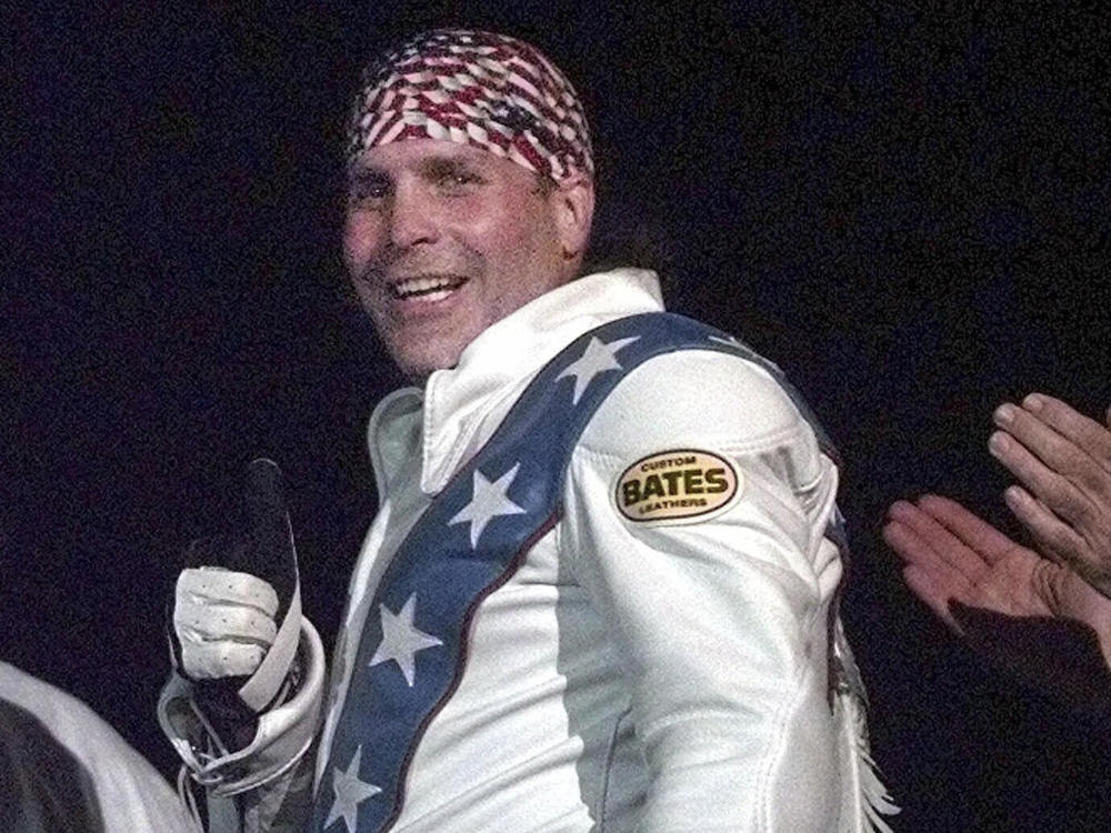 Robbie Knievel gives a thumbs up after jumping a train at the Texas State Railroad Park in Palestine, Texas on Feb. 23, 2000. Knievel, an American stunt performer, died early Friday at a hospice in Reno, Nev.