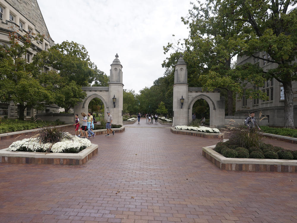 Students walk to classes on the Indiana University in Bloomington, Ind., in 2021. A student was stabbed on a bus near campus.