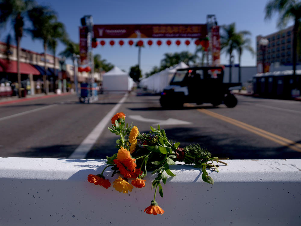 Flowers are placed near the scene of a deadly mass shooting in Monterey Park, Calif., on Sunday.