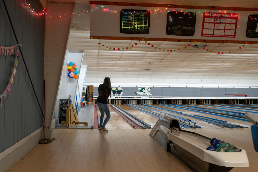 Autumn Mowery prepares the lane for a group of locals at the candlepin bowling alley in Ellsworth, Maine.