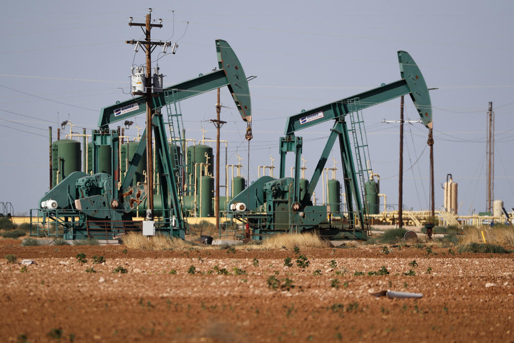 A a view of a pump jack operating in an oil field in Midland, Texas. A U.N.-backed study has found that the world needs to cut by more than half its production of coal, oil and gas in the coming decade to maintain a chance of keeping global warming from reaching dangerous levels.