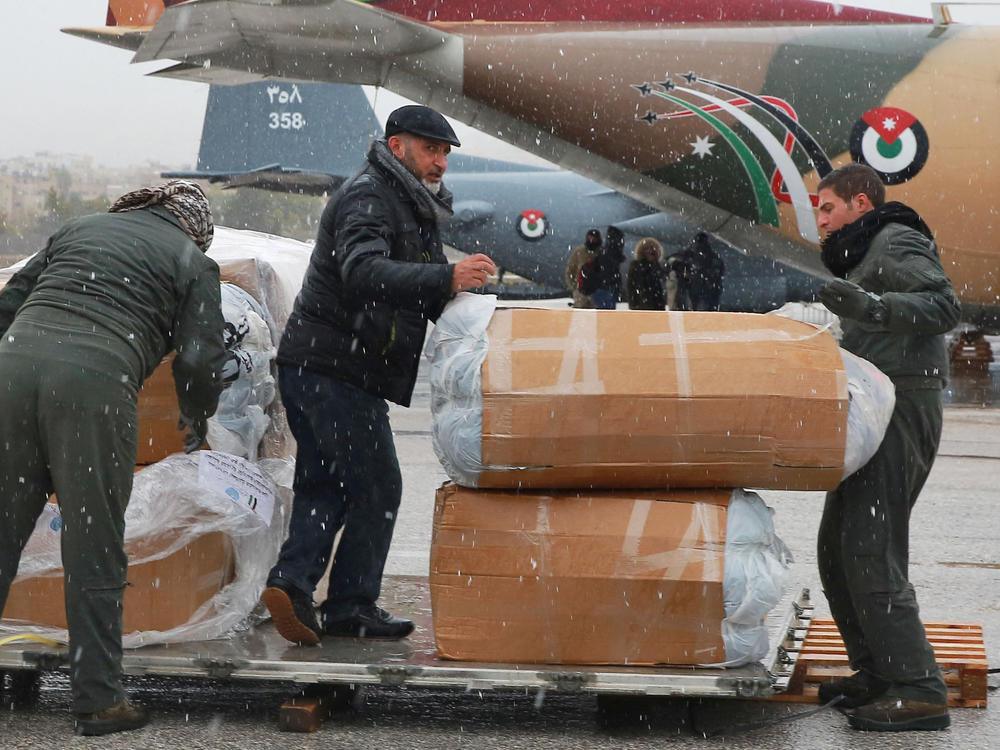 Jordanians load a military plane with humanitarian aid for Syria following a deadly earthquake, at Marka military airport in Amman, Jordan, on Feb. 8, 2023.